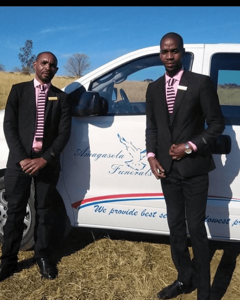Bearded senior man walking near woman with flowers on funeral
