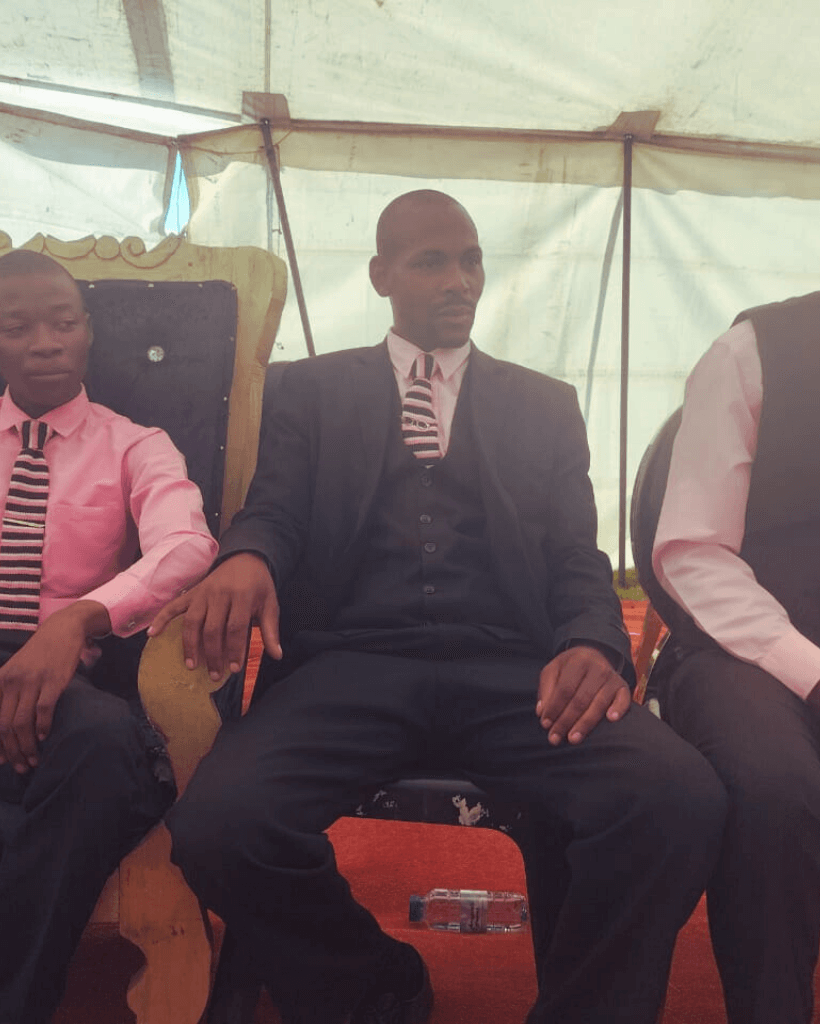 Bearded senior man walking near woman with flowers on funeral