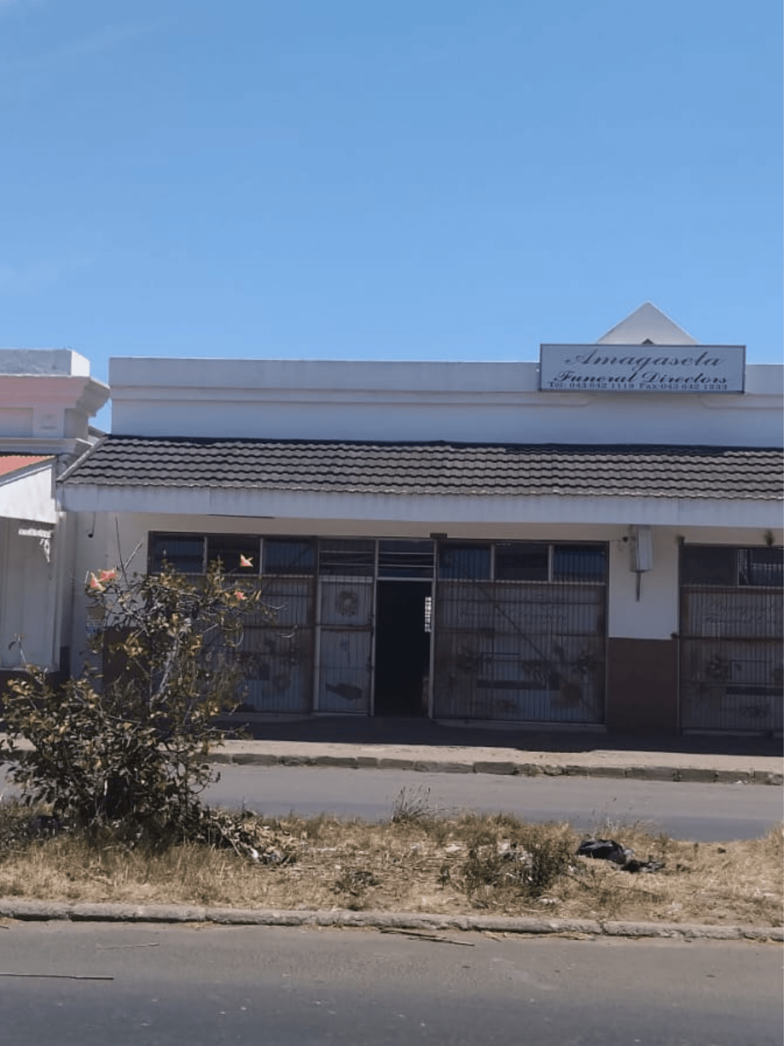 Bearded senior man walking near woman with flowers on funeral